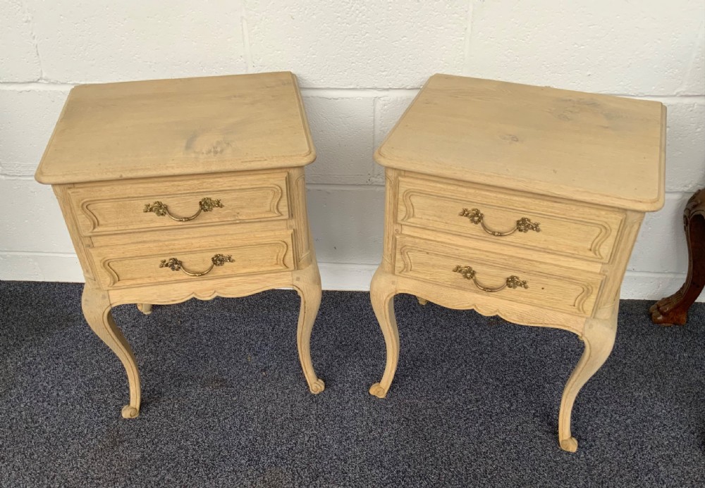 pair of bleached oak bedside cabinets
